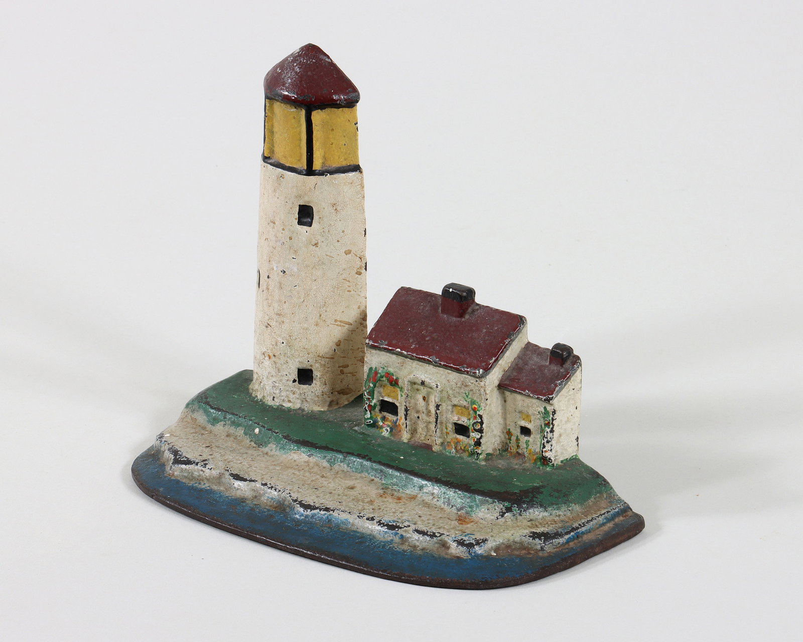 Lighthouse Painted Doorstop: Lighthouse Painted Cast Iron Doorstop probably design no. 95 by National Foundry, c. 1920s, no mark visible. 6 1/4 x 7 3/4 x 4 in. (15.9 x 19.7 x 10.2 cm.)