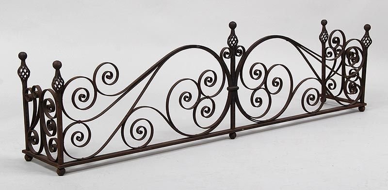 Wrought iron fireplace fender with open scroll work,: Wrought iron fireplace fender with open scroll work, 17''h, 58-1/2''w, 10''d.