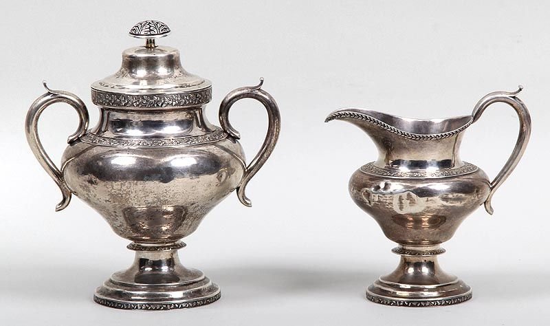 Set of (2) 18th/19th century American silver table: Set of (2) 18th/19th century American silver table articles by John Ewan, Charleston, S.C. in thistle pattern with makers' marks, to include a covered two handled urn and a small pitcher, total weight