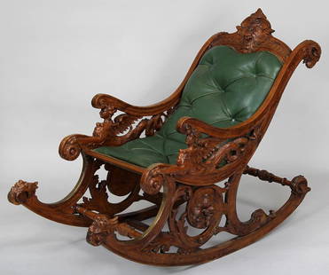 Renaissance revival ornately carved walnut rocking: Renaissance revival ornately carved walnut rocking armchair, 19th/20th century, 42''h, 27''w, 54''d; repairs and small losses. Provenance: Phipps Family, Long Island , New York.