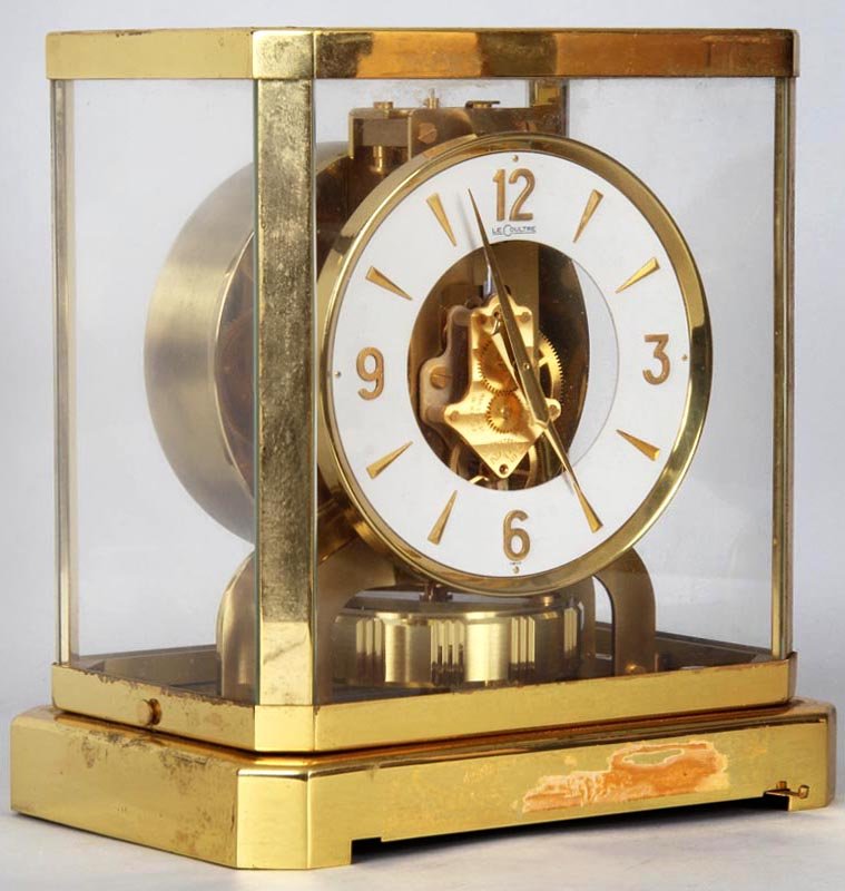 Swiss LeCoultre Atmos brass and glass cased clock with: Swiss LeCoultre Atmos brass and glass cased clock with open works, 9-1/4''h, 8-1/4''w, 6-1/4''d.