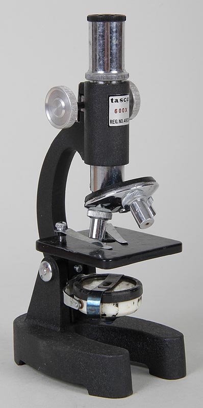 Tasco microscope, 600X, in wood case. 8''h. Some wear: Tasco microscope, 600X, in wood case. 8''h. Some wear from use.