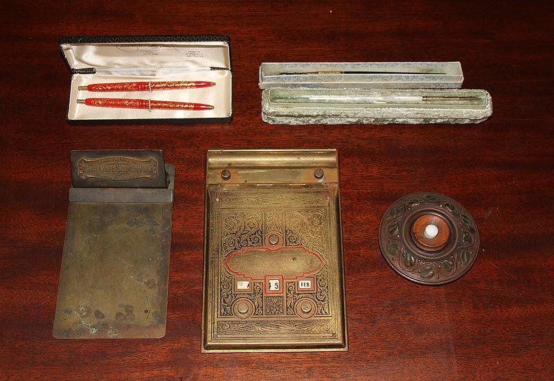 Group of (7) office accessories, to include: brass: Group of (7) office accessories, to include: brass clipboard, State Bank & Trust Co; desk calendar with date dials and enamel details; bell push with repousse escutcheon; Arpege ''My Sin'' pen set wit