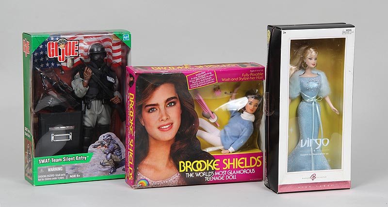 Group of (3) toys, new in box, to include: Brooke: Group of (3) toys, new in box, to include: Brooke Shields, The World's Most Glamorous Teenage Doll, 1982; GI Joe, SWAT Team Silent Entry, 2002; and Barbie Pink Label Virgo, 2004. Barbie 11''h.