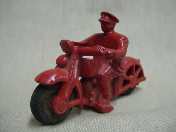 Old cast iron man on motorcycle toy