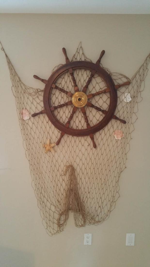 33 INCH CAPTAIN'S WOOD WHEEL DECOR WITH FISHNET: Oh, this would look wonderful over the bar with the compass. Or anywhere for that matter. Nice 33 inch captain's wheel or pilot's wheel with a fishnet to spruce up any nautical area of your home....or