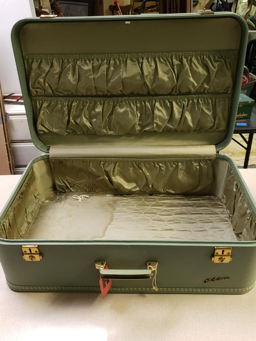 LADY BALTIMORE VINTAGE SUITCASE SAGE 26 IN LONG: These old suitcases can serve as so many new craft projects. Put a pillow or reline this one for your favorite tiny dog or kitty. They sell from $30-$35 each and the sage color is very popular. Made b