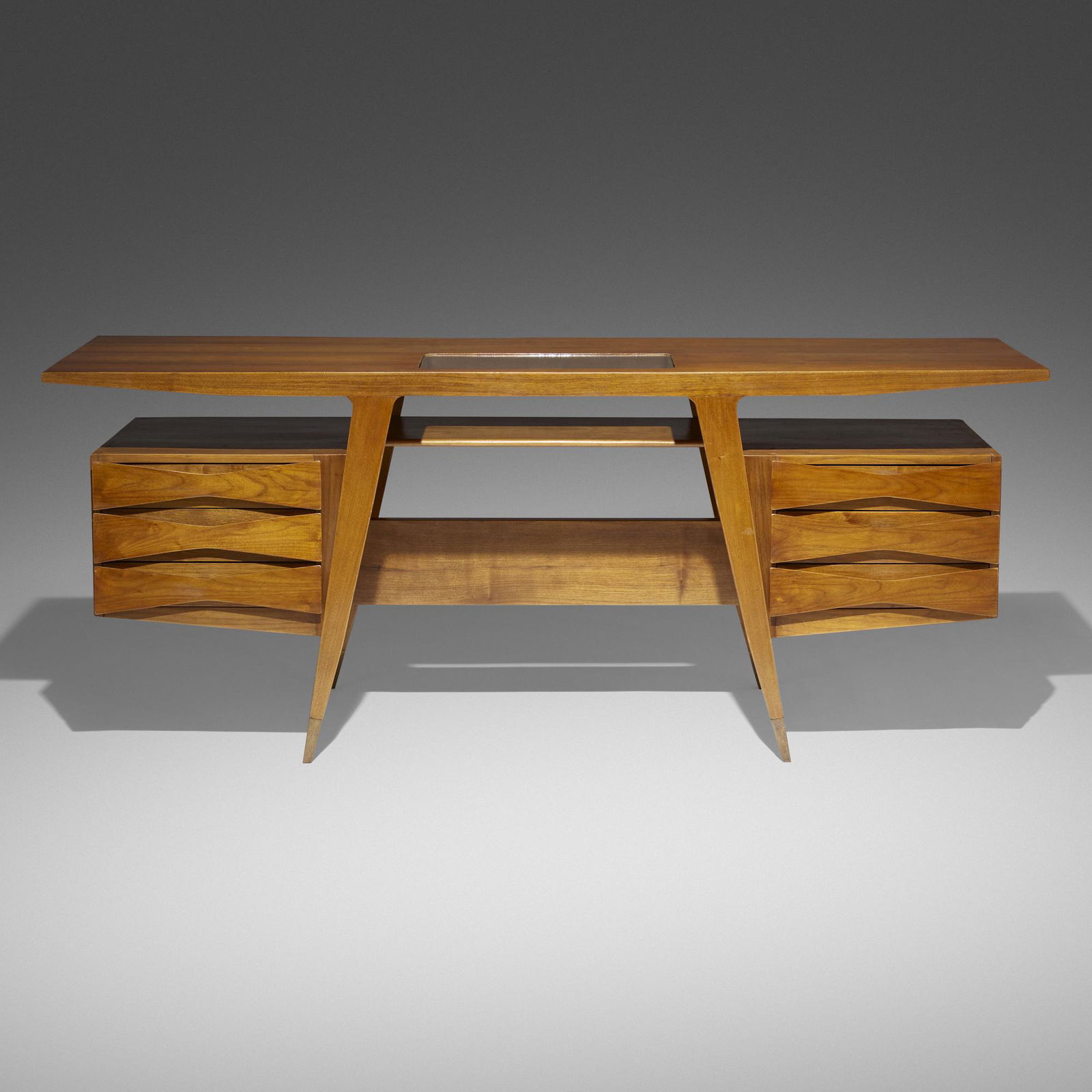 Gio Ponti, Executive desk: Gio Ponti Executive desk Giordano ChiesaItaly, 1950Italian walnut, brass, glass 31.5 h × 78.25 w × 27.125 d in (80 × 199 × 69 cm) Desk features six drawers and st