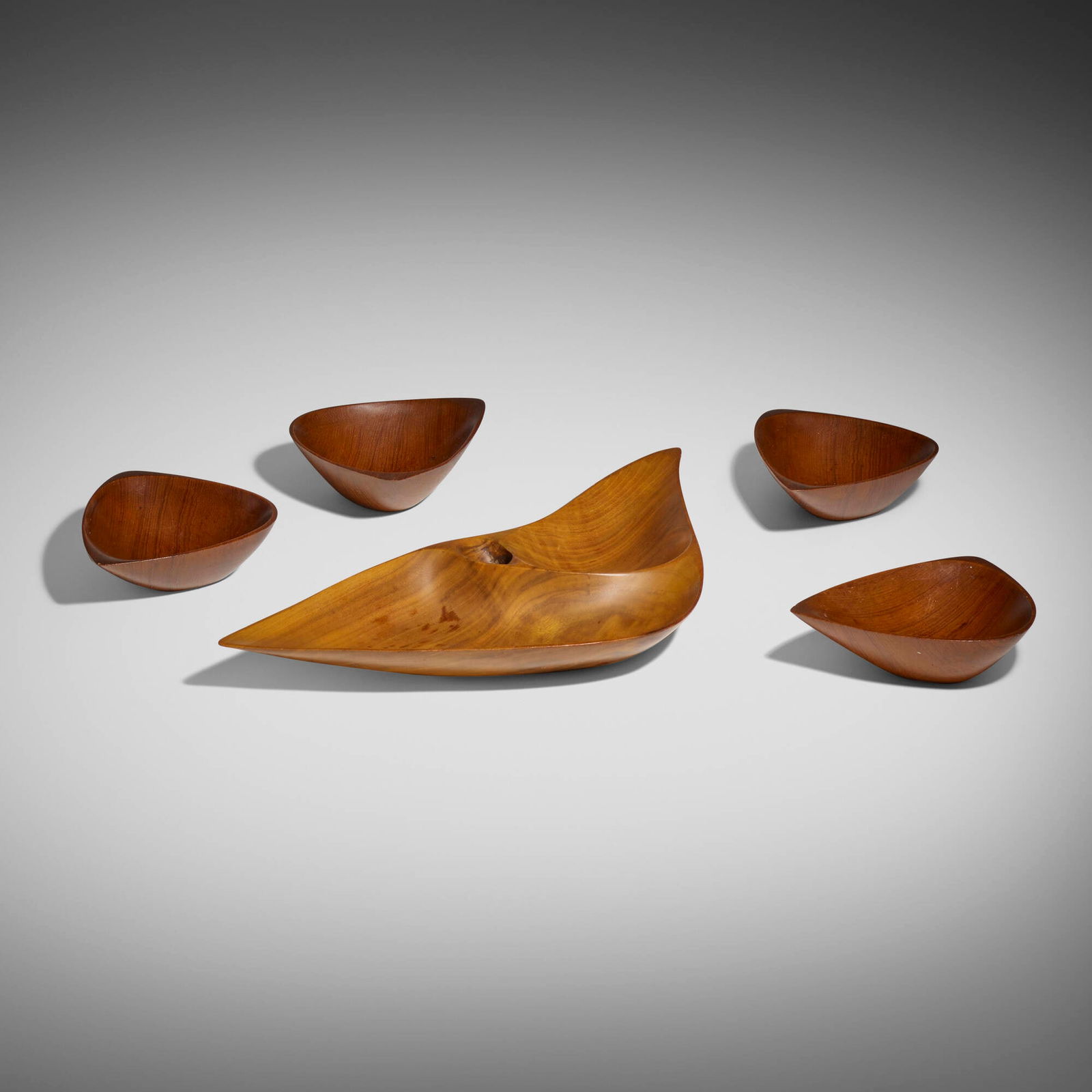 Emil Milan, Tray and four bowls: Emil Milan Tray and four bowls USA, 1950walnut, teak 1.75 h x 20 w x 8.75 d in (4 x 51 x 22 cm) 2 h x 7.25 w x 5.625 d in (5 x 18 x 14 cm) Carved signature, date and inscription to undersid
