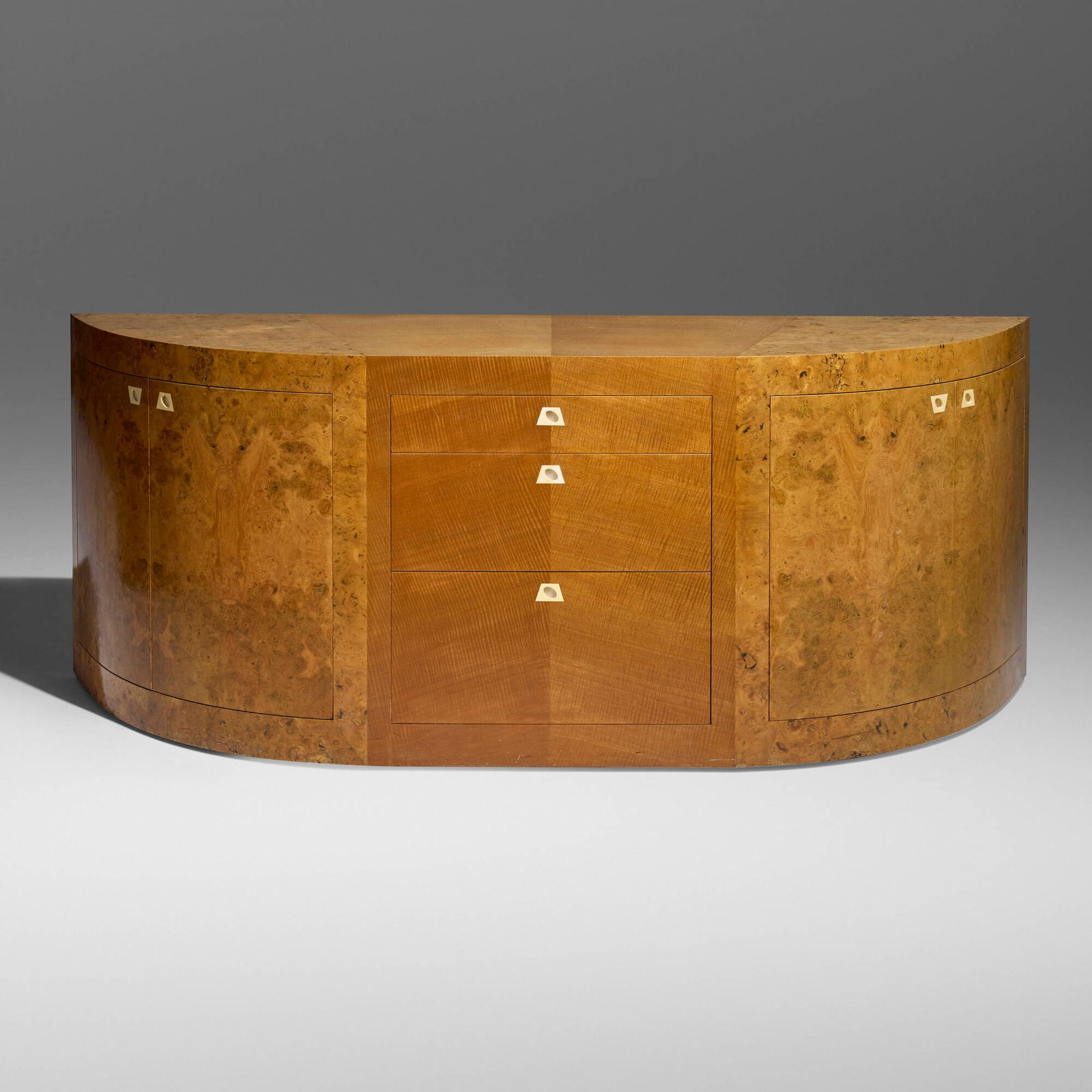 Larry Bell, De Lux Sideboard I: Larry Bell De Lux Sideboard I 1982Carpathian elm burl, makore, bone 36.000 h x 90.250 w x 28.750 d in (91 x 229 x 73 cm) Sideboard features three drawers and four doors concealing two shelves.