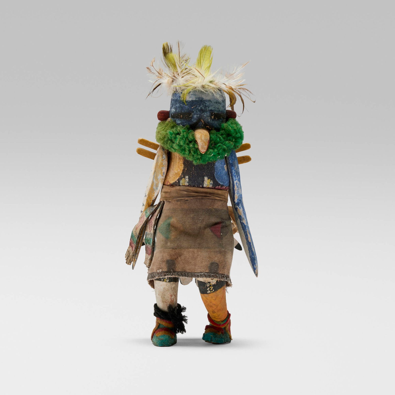 Zuni, Katsina doll representing Kakali, the Eagle: Zuni Katsina doll representing Kakali, the Eagle c. 1945wood, natural pigments, fur, ruff, leather, feathers 10 h x 5 w x 4 d in (25 x 13 x 10 cm) Provenance: Collection of Na