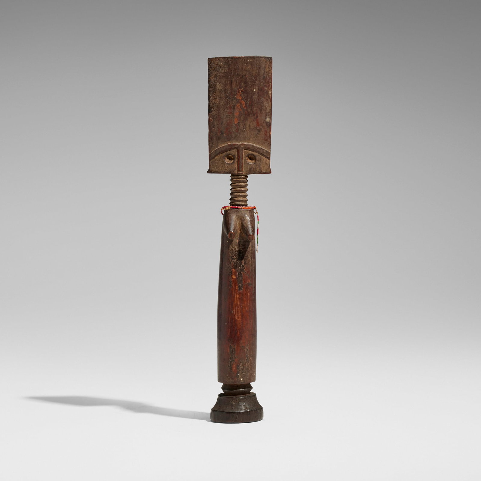 Fante, Akua'ba fertility figure: Fante Akua'ba fertility figure Ghana, 20th century carved wood, beads 11.25 h x 2 w x 1.5 d in (29 x 5 x 4 cm) Provenance: Collection of Lionel and Terry Bell