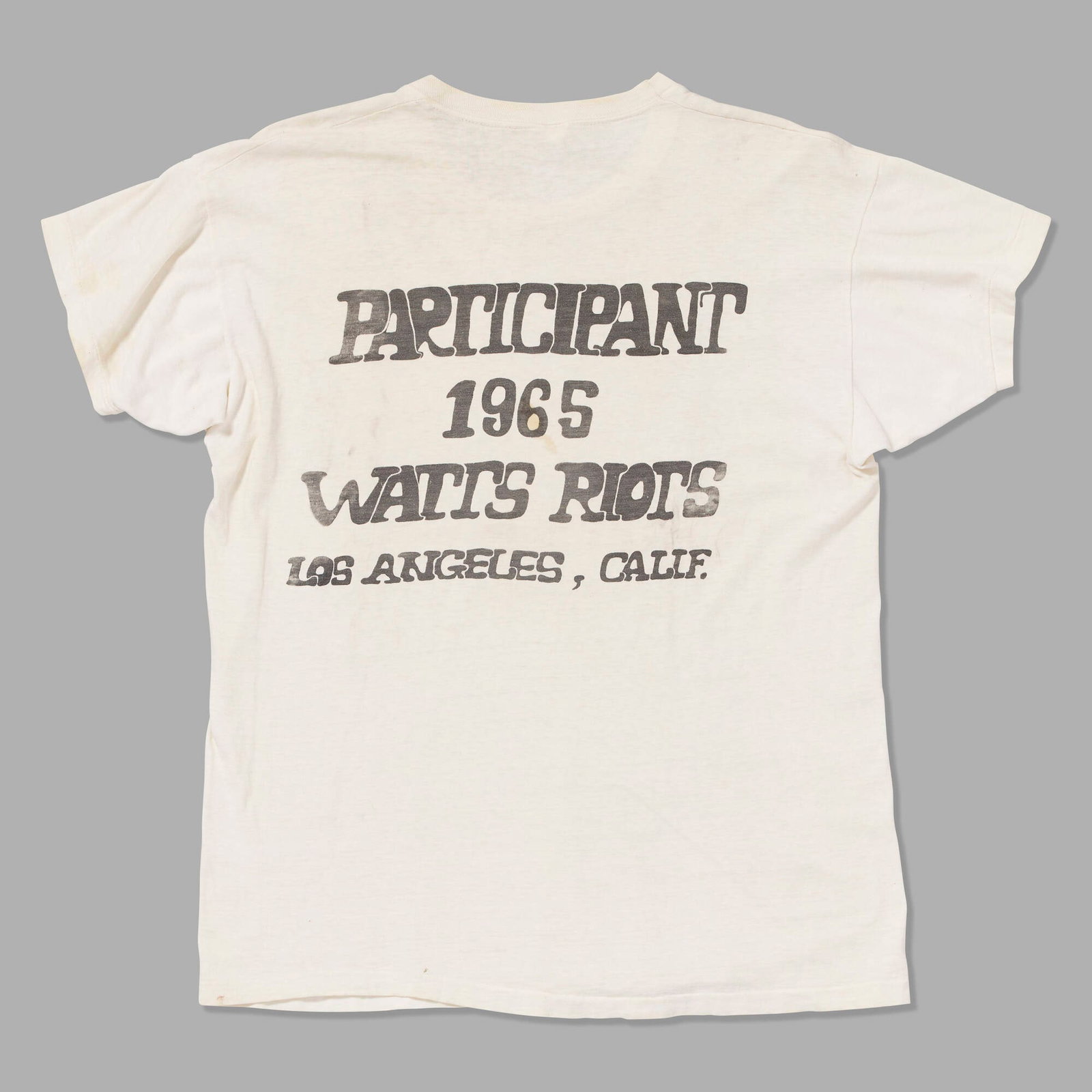 Watts Riots Participant vintage t-shirt: Watts Riots Participant vintage t-shirt poly-blend, single stitch 18.25 w x 26 l in (46 x 66 cm) The Watts Riots erupted in Los Angeles in August 1965 after the arrest of a young Black motorist escala
