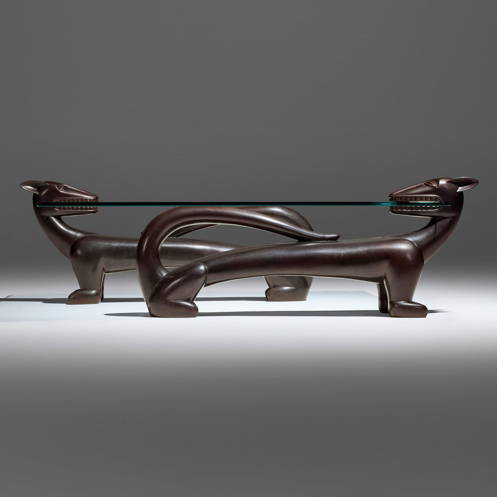 Judy Kensley McKie, Panther coffee table: Judy Kensley McKie Panther coffee table 1989 patinated bronze, glass 17 h x 47.75 w x 57 d in (43 x 121 x 145 cm) Incised signature, date and number to underside '?JKM 1989 AP/A' and 'AP/B'. This