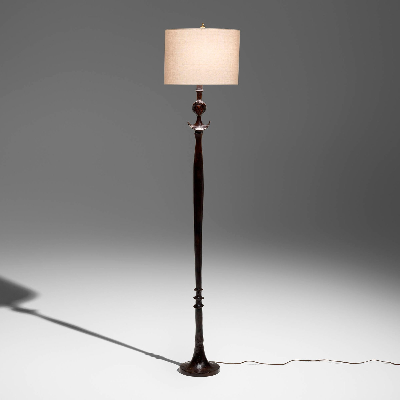 After Alberto Giacometti, Tete de Femme floor lamp: After Alberto Giacometti Tete de Femme floor lamp Excalibur Bronze 1985 patinated bronze, brass 71.75 h x 8.5 dia in (182 x 22 cm) Impressed manufacturer's mark to base 'EX NY�
