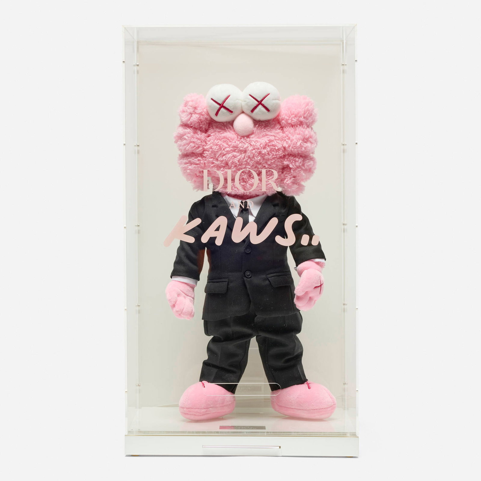 KAWS (Brian Donnelly), Dior BFF (Pink): KAWS (Brian Donnelly) Dior BFF (Pink) 2019 polyester plush in Dior suit 18.5 h x 9 w x 3.75 d in (47 x 23 x 10 cm) Applied metal manufacturer's mark to base 'Dior and Kaws.. Limited Edition