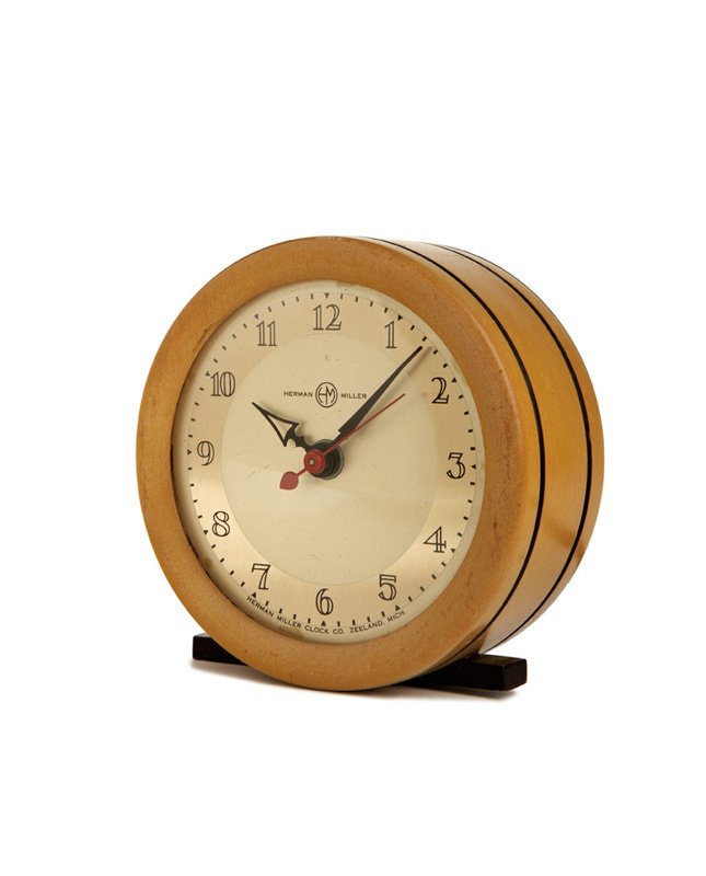 Gilbert Rohde, Table clock: Gilbert Rohde Table clock Designed 1937 Enameled metal, limed wood, glass Model no. 6345 Herman Miller Retains manufacturer's marks 4.25" x 4.5" x 2" Literature: Herman Miller Clock Company. Catalogue