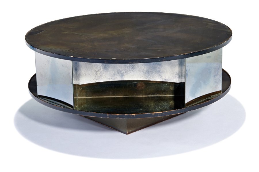 Paul Laszlo, Coffee table with mirrored top: Paul Laszlo Coffee table with mirrored top Executed 1946 Custom 17" x 39.5" diameter Provenance: Commissioned for Rene Williams, 606 North Beverly Drive, Beverly Hills, California Estimate: $2000 - $3