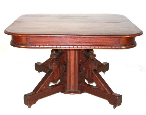 American Walnut Victorian Dining Table with Incise: American Walnut Victorian Dining Table with Incised Carved Skirt & Base with Rosettes & Finials in Original Finish with Eight Original Leaves and Rack. Circa 1870. 29"h x 48"d, extends to 143"