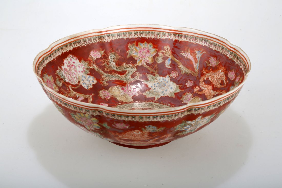 A ENAMEL EGGSHELL PORCELAIN BOWL.C422.: A ENAMEL EGGSHELL PORCELAIN BOWL.C422. China, 20th century, depicting scrolling dragons and pearls surrounded with flowers on a red ground, iron red Qianlong mark to base.C Provenance: SKINNER, INC Bo