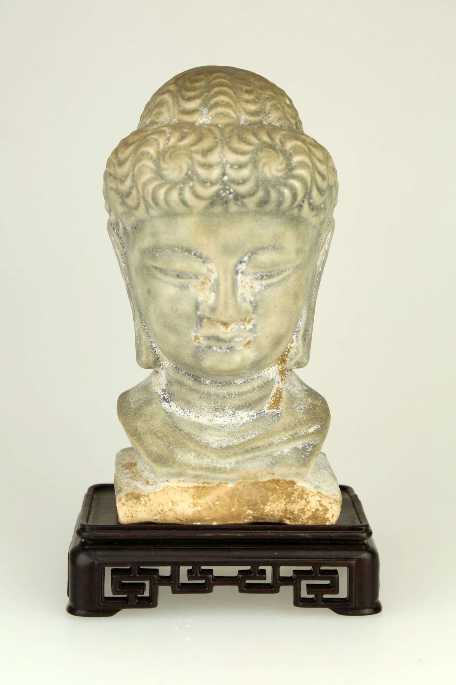 A CHINESE CELADON BUDDHA HEAD STATUE.C147. (1 of 4)