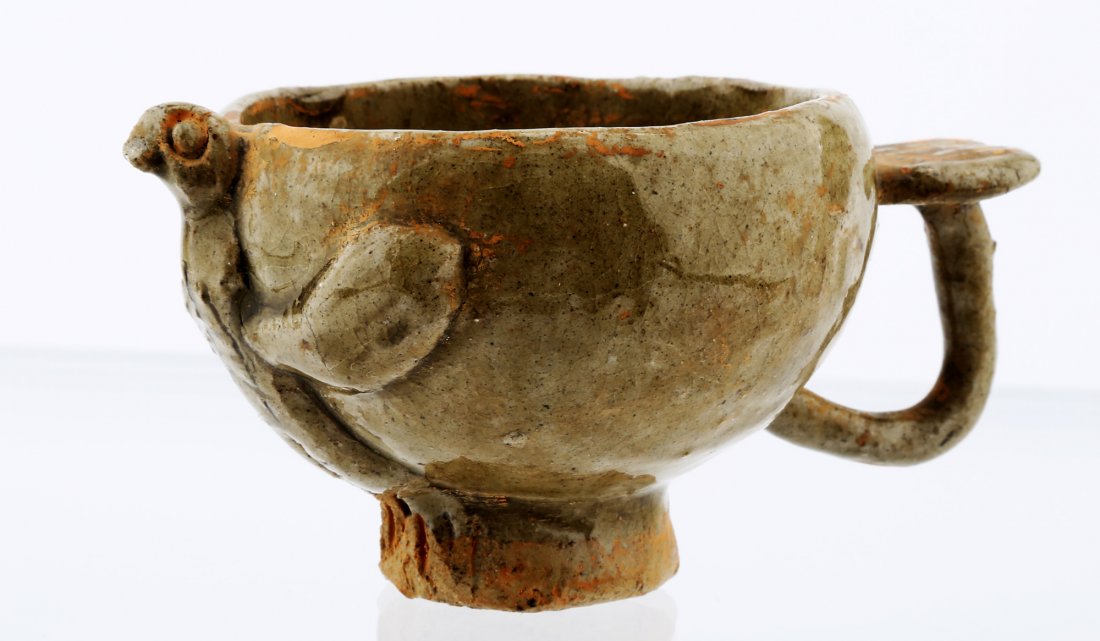 A CHICKEN-HEAD FORM CELADON CUP: A CHICKEN-HEAD FORM CELADON CUP China. Probably Ming dynasty or Song dynasty and later. Measure: Height 2.63 ", diameter 3.25". CONDITION: No other signs of damage, loss or repair. overall wear due to