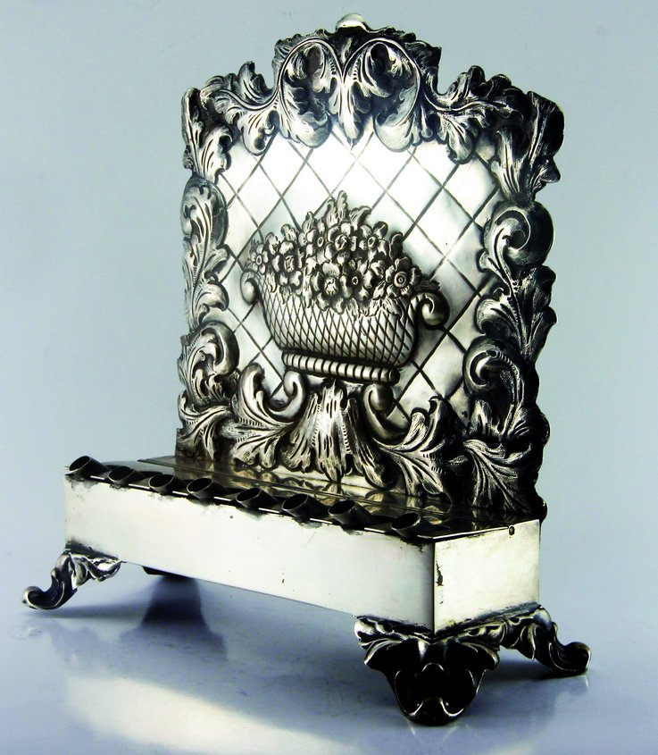 Chanuka Menorah. Silver. Central Europe.: Chanuka menorah. Silver. Maker's mark– "L. Schlesinger". Additional hallmarks on the interior of the backplate.The hallmarks are covered by the beakers – can be viewed upon removal of two screws.I