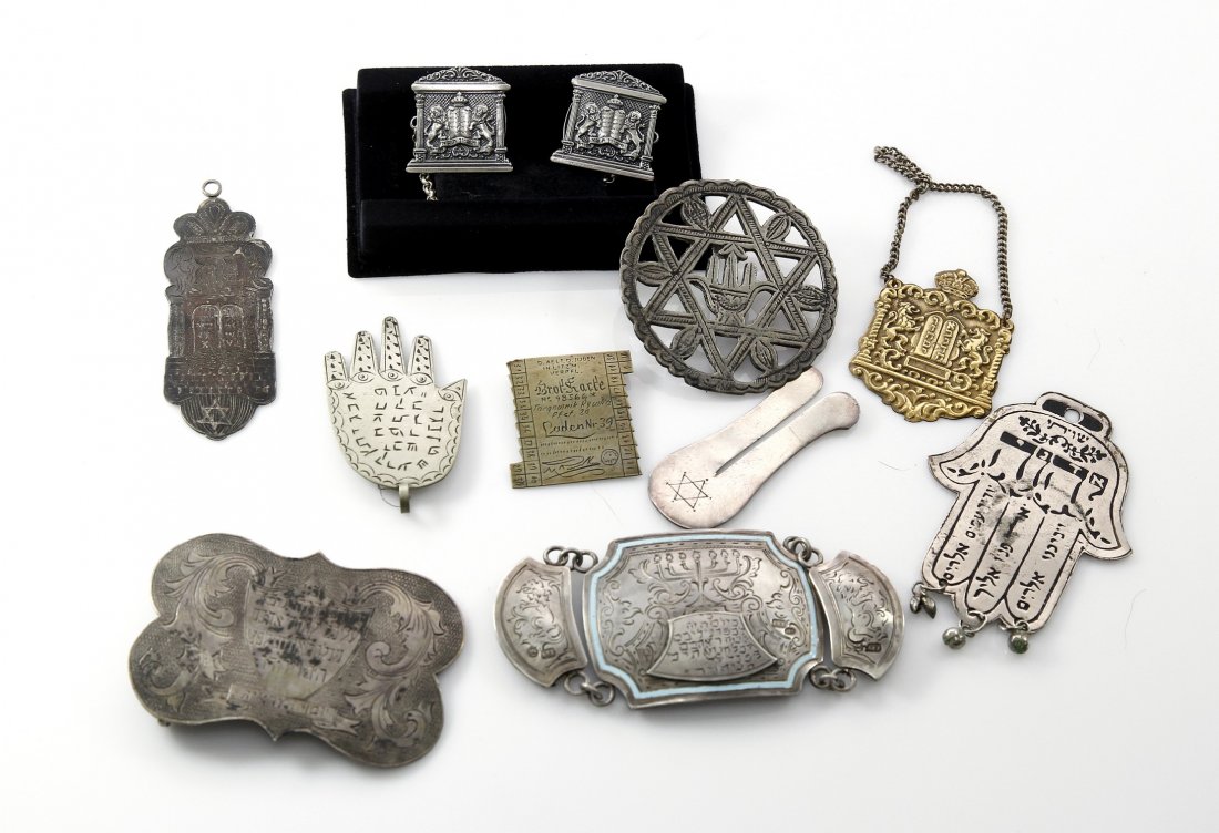 Collection of Silver and Metal Accessories. (8).: "Magen" for a circumcision. Clasps for a Torah Scroll. Pendant. Tallit holder. Amulets.