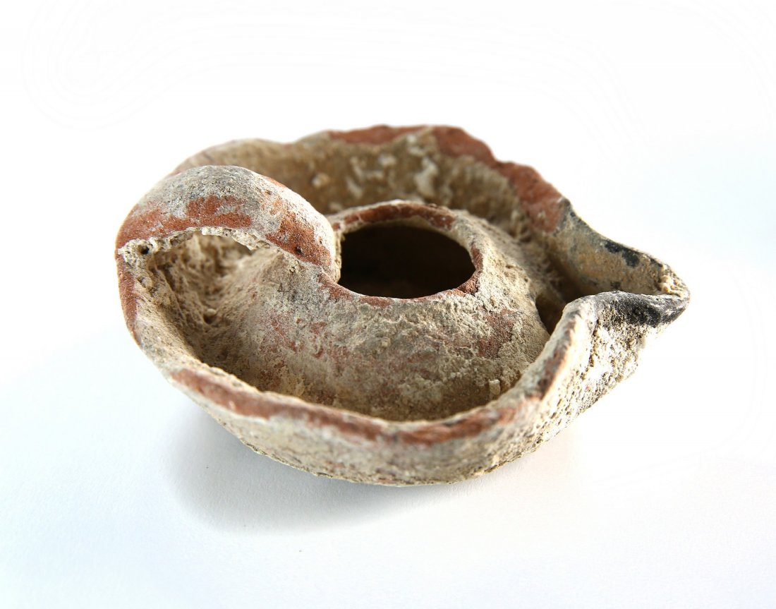 Terracotta lamp with lug handle; bowl-shaped reservoir: Crusader Period â€“ when European Christians came to the Holy Land to recapture the Church of the Holy Sepulchre. Cf. Knights of the Holy Land, p.262 for related material. The problem in attribut