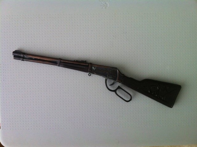Antique TOY CARBINE SHOTGUN Miniature: For auction is a miniature carbine shotgun made of metal brass about 11 inches long. It has the skull image on one side of the handle, and the other side has a pony and dream catcher image. The profil