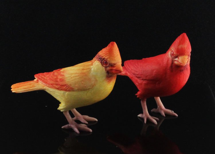 Two Polychromed Ivory Bird Figures: Two Polychrome Ivory Bird Figures 2" long. The two painted carved figures depicting a male and female cardinal. Please note, this lot cannot be shipped internationally or to the State of California. E