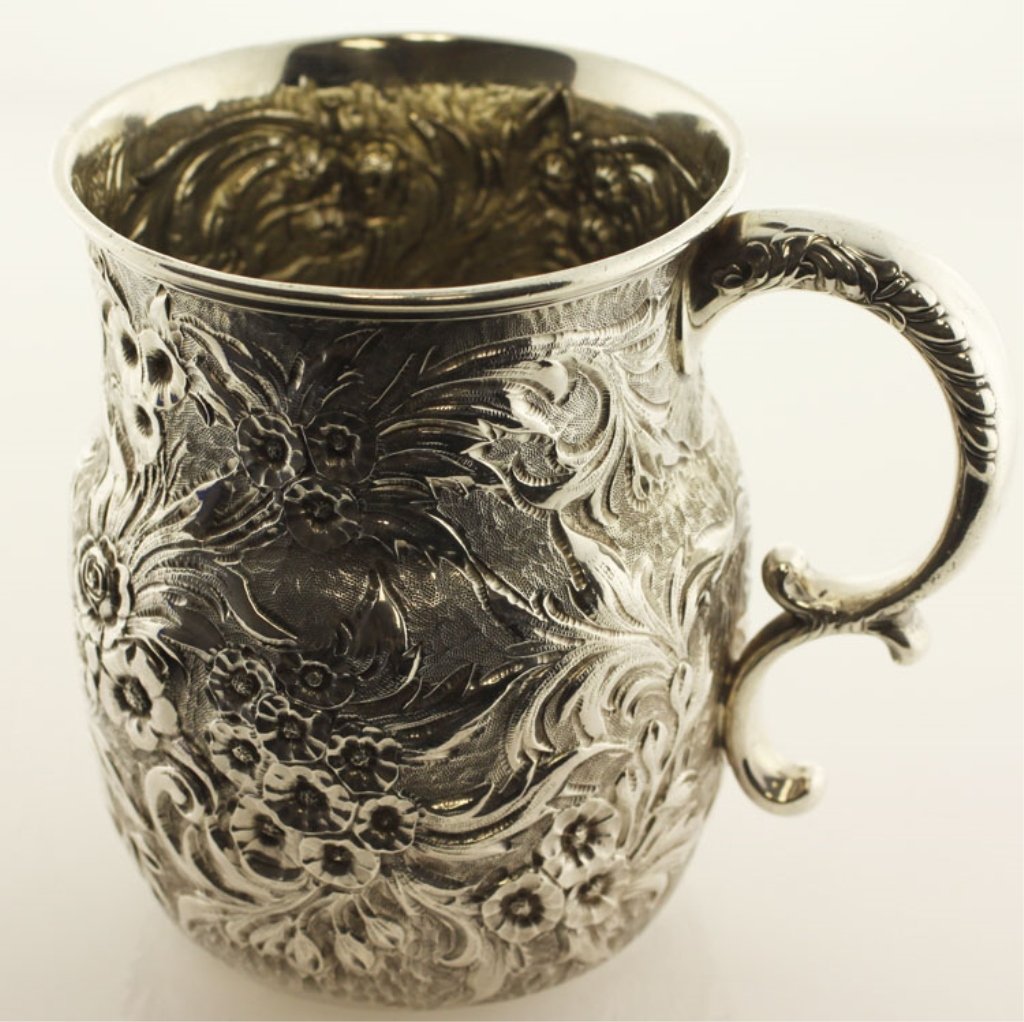 Whiting Silver Repousse Mug: EST 150-250 Whiting Manufacturing Co., New York, New York, circa 1900. Marks: (W with griffin), STERLING, 2752E, THEODORE B STARR 3 5/8" high. 4.81 troy ounces. The shaped mug with repousse floral and