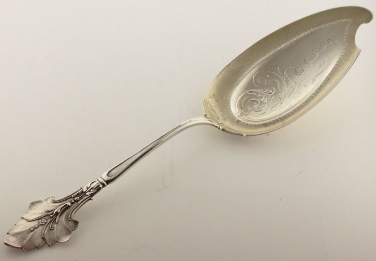 Wood & Hughes Silver and Silver Gilt Lily Patter: EST 150-250 Wood & Hughes, New York, New York, circa 1870. Marks: W&H, STERLING. 10 1/2" long. 2.88 troy ounces. The server in the Lily pattern with shaped gilt blade with bright cut floral and scroll