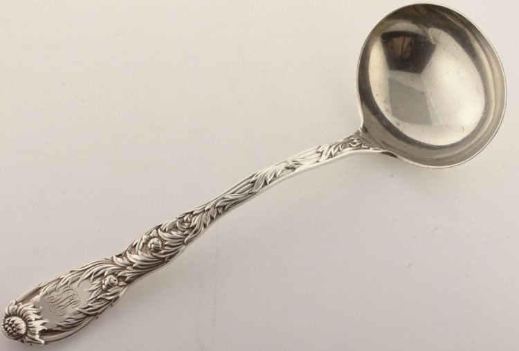 Tiffany Silver Chrysanthemum Pattern Gravy Ladle: EST 150-250 Tiffany & Company, New York, New York, designed 1880. Marks: TIFFANY & CO., STERLING, PAT 1880, M. 7 1/4" long. 3.19 troy ounces. The gravy ladle in the Chrysanthemum pattern, monogrammed 