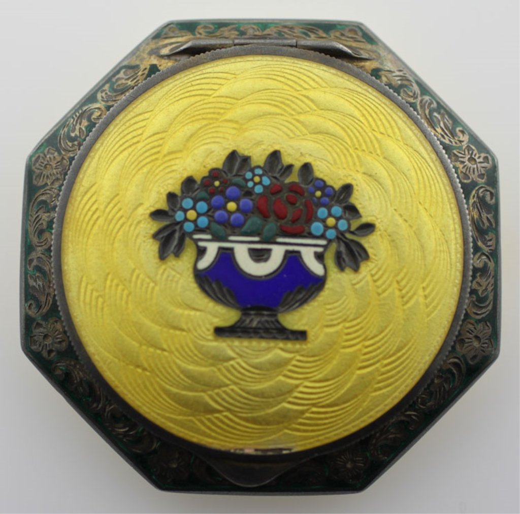 Vintage Austrian Compact Champleve Design Sterling: Est. $400-$600 Vintage Austrian Compact Champleve Design Sterling. Sterling 69.77 grams total weight. Wonderful yellow enamel front and back trimmed in green with multicolor floral design. 2 1/4 inche