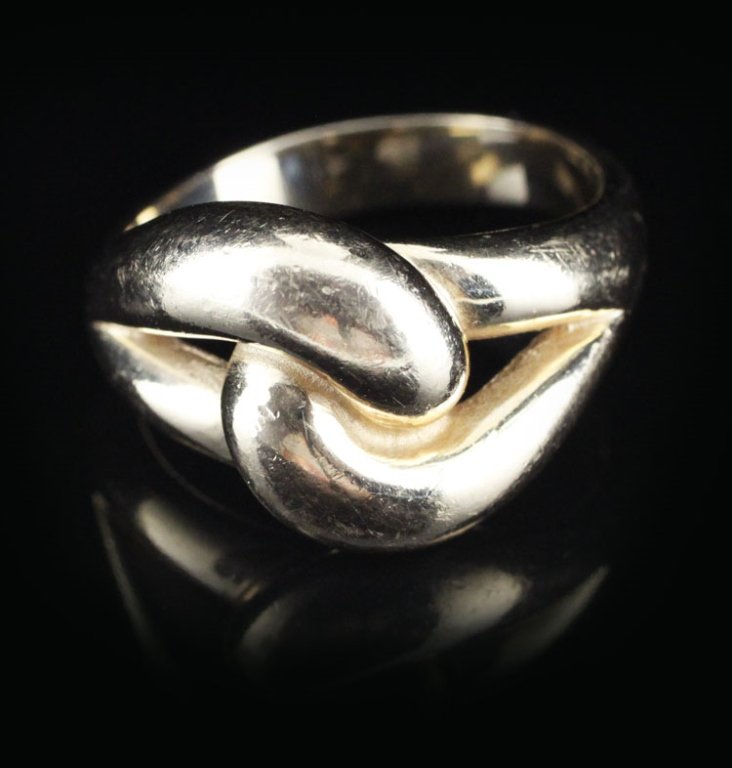 James Avery "Cadena" Ladies Ring in Yellow Gold: Est. $400-$600 James Avery "Cadena" Ladies Ring in Yellow Gold. 14kyg 9.90 grams. Interlocking design. 14.50mm at widest point. Markings James Avery and 14k.