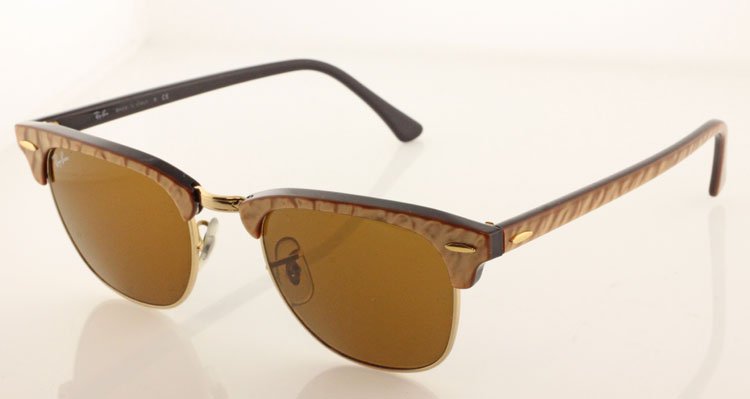Vintage Ray Ban Sunglasses: Est. $125-$250 Vintage Ray Ban Sunglasses. Gold Tone pearl finish on black. "Clubmaster" RB3016 987. Gold Frame with case.