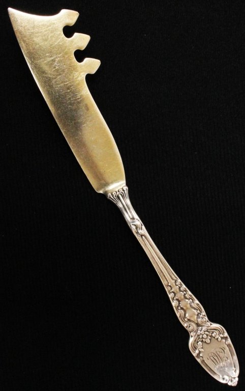 Tiffany Silver & Gilt Broom Corn Cheese Knife: Est $ 50 - 80 Tiffany Silver & Gilt Broom Corn Cheese Knife • made by Tiffany & Co. of New York, NY and was designed in 1890 • bears the marks: TIFFANY & CO, STERLING, M • 7 1/4" in length and w