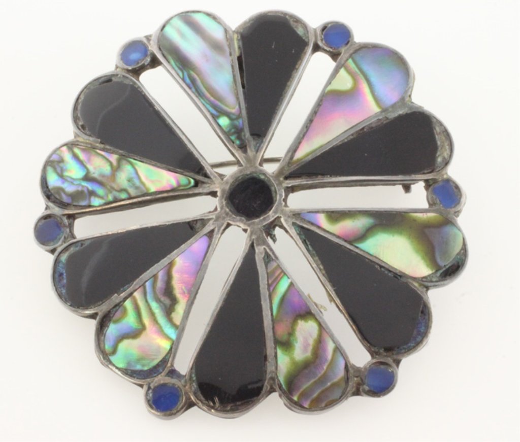 Sterling Brooch/Pendant with Onyx & Abalone: Est. $30 - 70 Sterling Brooch/Pendant with Onyx & Abalone Sterling weight is approx. 5.78 grams. Piece can be worn as a brooch or pendant. Incorporates black onyx and abalone. 1 1/2 inch diameter.