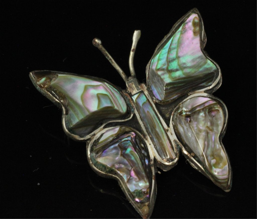 Small Silver Butterfly Brooch with Abalone: Est. $20 - 30 Small Silver Butterfly Brooch with Abalone. Silver tone finish with hand carved abalone accents.