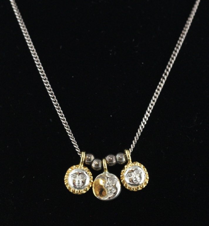 Sergio Bustamante Sun Moon Charms on Silver Chain: Est. $150 - 300 Sergio Bustamante Sun Moon Charms on Sterling Chain. Necklace is approx. 16 inches long. Sun/Moon charms are approx. 1/4 inch diameter. Hand Signed.