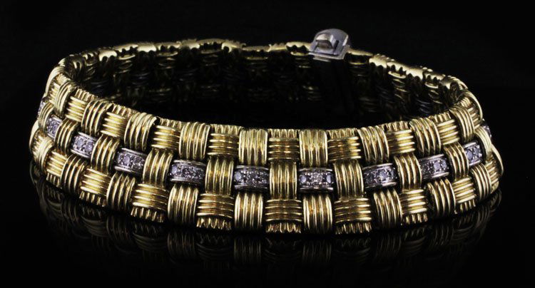 Roberto Coin Appassionata 18k Bracelet with Diamonds: Roberto Coin Appassionata bracelet with three rows of 18k yellow gold woven together and the signature ruby on the inside. It is adorned with (82) diamonds with an approx 1.00 cttw. It measures 7.25��