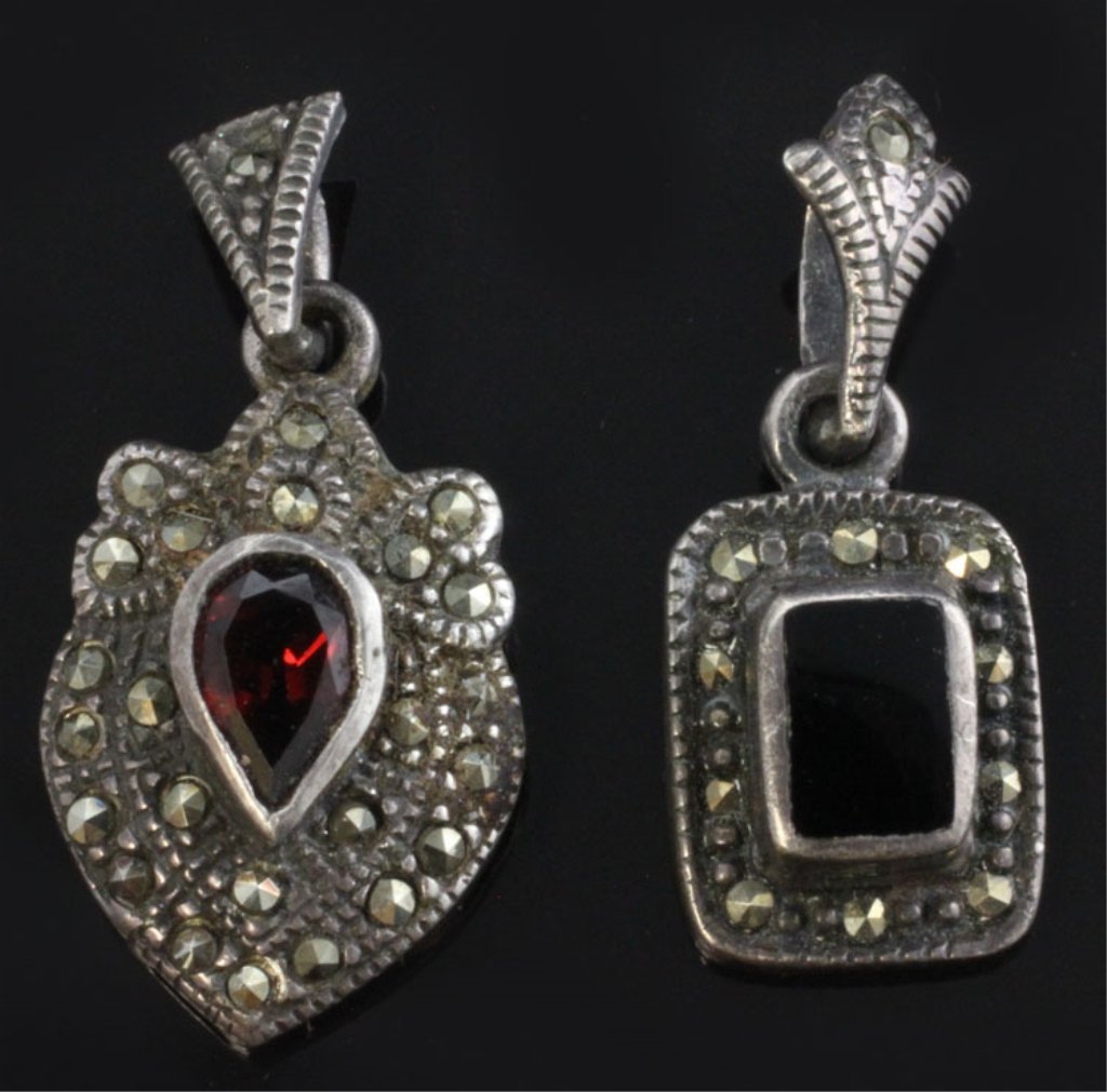 Vintage Pair of Sterling & Gemstone Pendants: Est. $30 - 50 Pair of Small Vintage Sterling & Gemstone Pendants. Sterling weight is approx 3.64 grams. Shield shaped pendant has pear cut garnet 6.70 X 4.50mm. Accented with marcasite 7/8 X 1/2