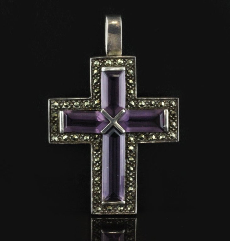 Large Amethyst and Marcasite Cross in Sterling: Est. $100 - 175 Large Amethyst and Marcasite Cross in Sterling . 13.8 grams. Gemstones (4) Amethyst step cut surrounded with marcasite accents. 2 3/8 X 1 1/2 inches. Estate piece.