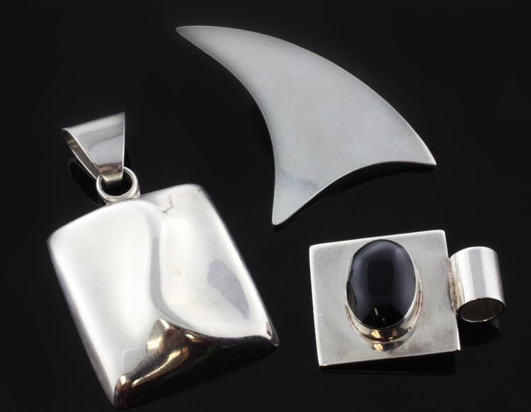 Lot of (3) Modern Style Pendants in Sterling: Est. $75 - 125 Lot of (3) Modern Style Pendants in Sterling. 29.9 grams total weight. This lot includes (3) unique designs. The largest is 1 3/4 X 1 inch. A fin or sail design that is 1 1/4 X 1 1/8 in
