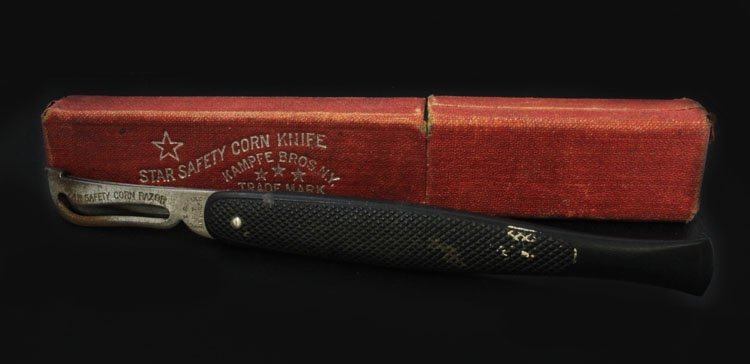 Star Safety Corn Knife: Est. $25 - 40 Star Safety Corn Knife. Corn knife with blade. Cloth covering is pulling away from cardboard case.