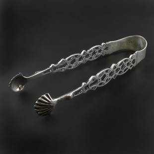 Sterling Sugar Tongs: Est. $ 60 - 80 Sterling Sugar Tongs. Silver tongs with a pierced design terminating into shells, Makers mark HF, marked england and shows the I date mark of 1904. 4 1/2" long x 1" wide and weighs .89