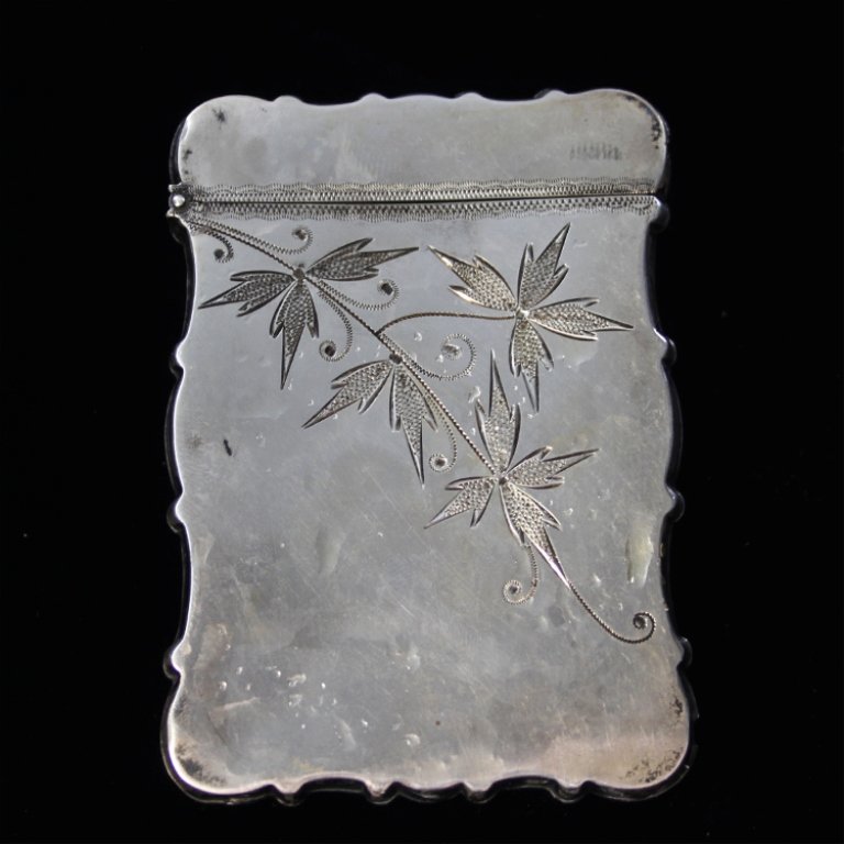 Wood and Hughes Card Case: Est. $ 50 - 80 Wood and Hughes Card Case Floral engraved design. Marked Sterling, 17, W&H. Measures 3.5" x 2.5". Weighs 1.105 ozt.