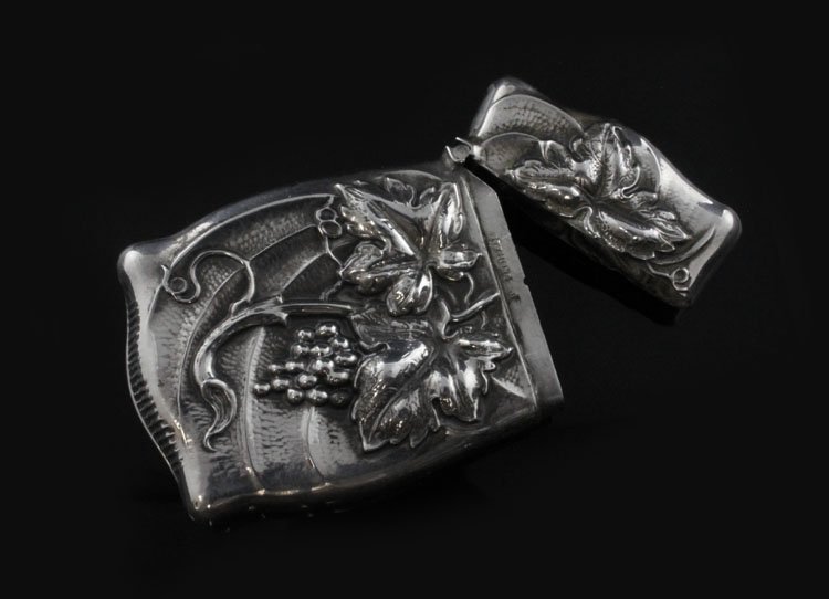 Sterling Vesta Case: Est. $ 30-45 Sterling Vesta Case Has a Grapevine pattern, marked sterling, G and weighs .48 troy oz, 2 1/2 x 1 1/2" wide.