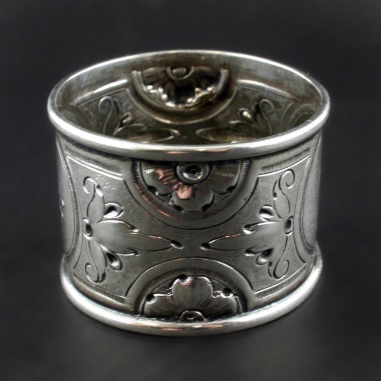 Sterling Napkin Ring: Est. $ 30 - 50 Sterling Napkin Ring Jane engraved on the ring, no marks observed, has a repousse floral décor. Late 19th century early 20th century, 1 7/8" in diameter x 1 1/4" wide and weighs .89 oz